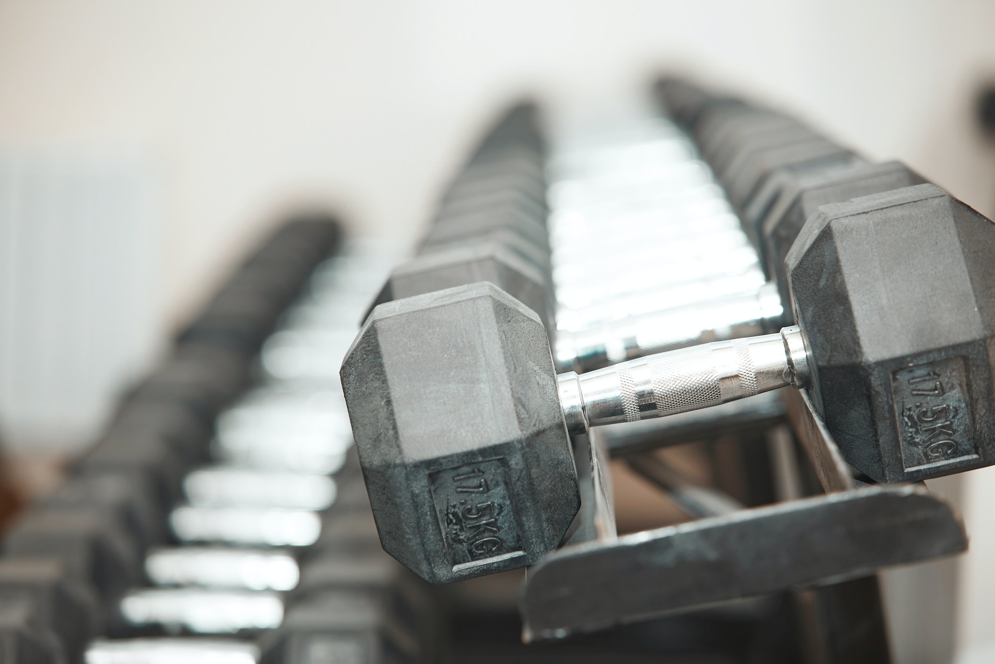 Row of barbells in gym room